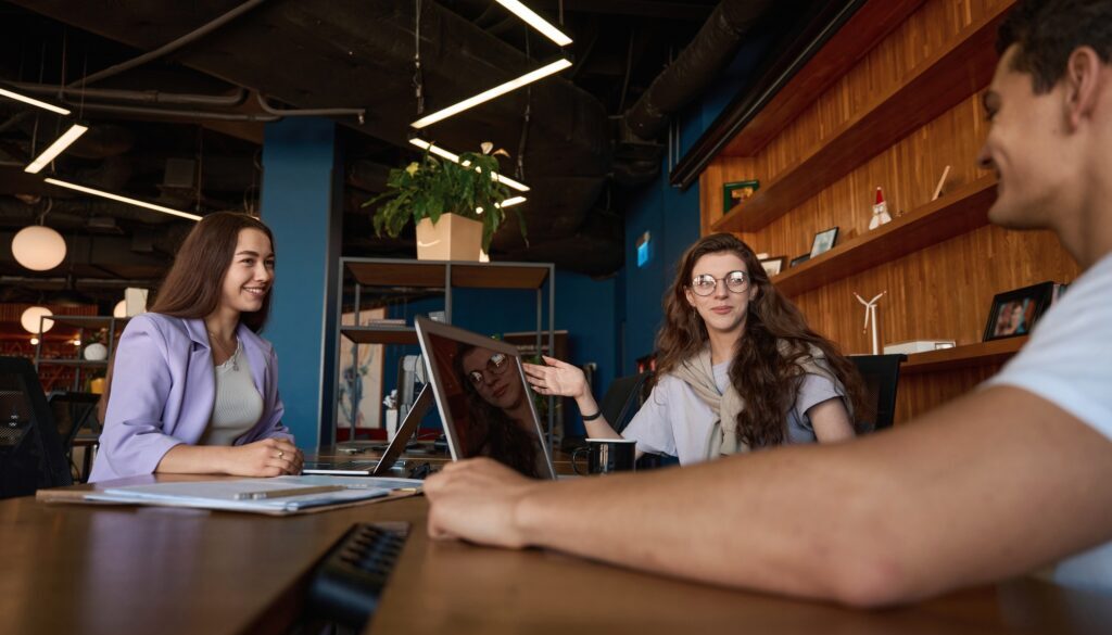 Friendly office team discussing workflow at a table in office